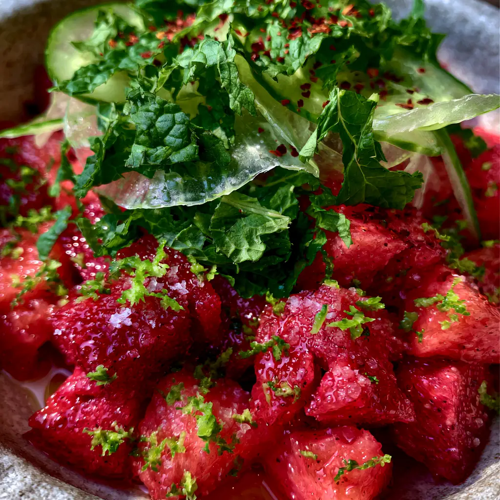 Watermelon recipes: The Ultimate Chilled Honey-Lime Salad with Persian Cucumbers 2 Top-down close-up of jagged ruby-red watermelon cubes glistening with honey glaze and lime zest. (watermelon recipes)