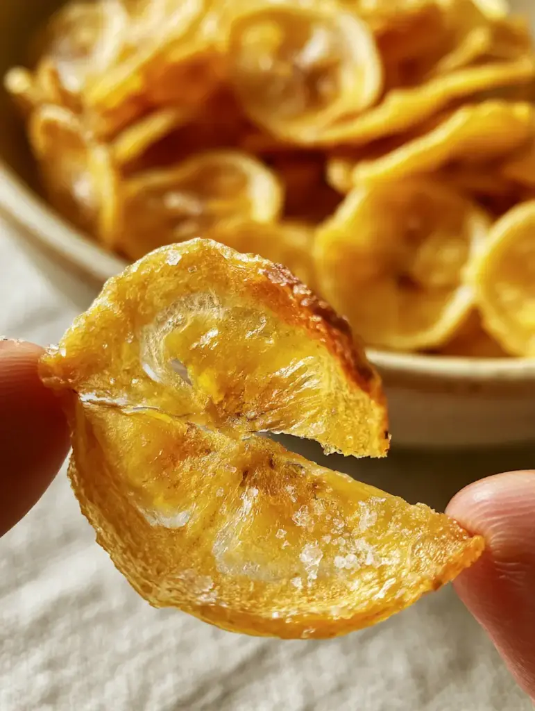 Close up of air-fried banana chips showing amber caramelized edges and a zero-oil matte finish.