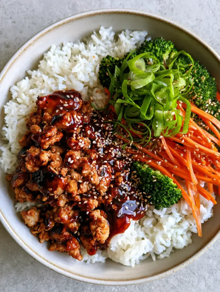Ground Turkey Teriyaki Rice Bowls with Glossy Mahogany Glaze 2 Top-down view of a Ground Turkey Teriyaki Rice Bowl with fluffy jasmine rice, seared meat, and julienned carrots. (Ground Turkey Teriyaki Rice Bowls)