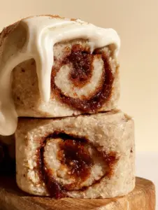 Extreme close-up of Raw Vegan Cinnamon Rolls showing the dense, moist tan dough and dark glistening cinnamon-date filling.