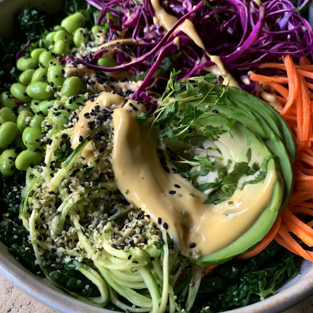 Raw Vegan Diet Abundance Bowl with Creamy Lemon-Tahini 2 Close-up of massaged kale and zucchini noodles in a Raw vegan diet bowl.